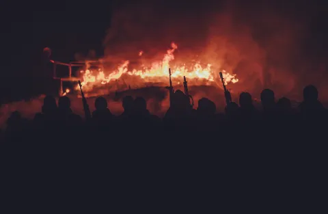 Azov regiment soldiers attend a ‘traditional viking ceremony’ standing with torches in front of a burning replica of a Drakkar viking ship in the Rivne region, Ukraine, Thursday December 22 2022