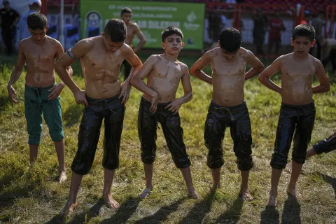 Young wrestlers getting ready to start a round during the 664th annual Historic Kirkpinar Oil Wrestling championship, in Edirne, northwestern Turkey, July 6, 2025