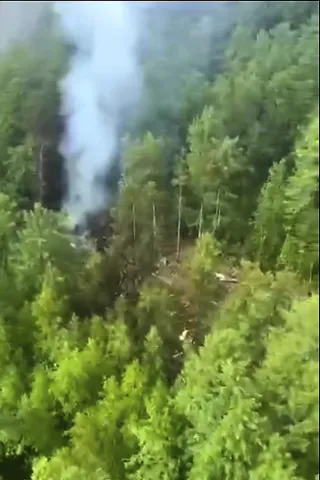 In this photo taken from video released by Russia Emergency Situations Ministry press service on, July 24, 2025, smoke rises from the crash site of a Russian An-24 passenger plane of the Siberia-based Angara Airlines about 9 miles south of Tynda, Far Eastern Amur region of Russia