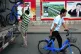 Chinese workers unloading bicycles to stock an urban bike-sh