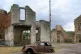 A decayed Peugeot 202 and some buildings in Oradour-sur-Glan