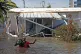 STRANDED: A resident wades through floodwaters in a flooded 