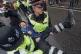 An XR activist is carried away from a blockade in the City o