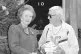 Rapist Jimmy Savile poses with Thatcher as he hands her two 