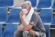 A spectator wears a mask as smoke haze shrouds Melbourne dur