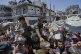 Palestinians receive donated food at a distribution center in Beit Lahia, northern Gaza Strip, Tuesday, April 29, 2025