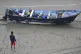 A Del Mar lifeguard looks over a capsized boat on the beach at Torrey Pines State beach in San Diego, California,  May 5, 2025