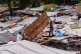 People repair a roof in a makeshift a shelter for families displaced by gang violence in Port-au-Prince, Haiti, Monday, May 5, 2025
