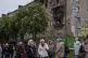 A municipal worker clear the rubble from a balcony of a residential building damaged after a Russian strike in Kyiv, Ukraine, May 7, 2025