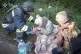 In this photo provided by the Ukrainian Emergency Services on May 8, 2025, a rescue worker helps an injured elderly woman evacuated from a building which was heavily damaged by a Russian strike in Sumy region, Ukraine