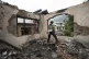 A Kashmiri village boy walks inside a house damaged by Pakistani artillery shelling, at Salamabad village in Uri ,north of Srinagar, Indian-controlled Kashmir, May 8, 2025