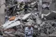 In this photo provided by Ukraine's 93rd Kholodnyi Yar Separate Mechanized Brigade press service, a man waits to hear about his missing wife as rescuers clear the rubble of a multi-storey residential building destroyed a day before by a Russian airstrike, in Kostiantynivka, Ukraine, on Thursday, May 8, 2025. 