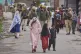 Kashmiri villagers are escorted by police as they walk after they are evacuated from their village following overnight shelling from Pakistan in Uri district, Indian controlled Kashmir, Friday, May 9, 2025