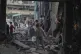 Palestinians inspect the damage at a UN school used as a shelter by displaced people that Israel bombed, killing more than 15 people, in Jabaliya, northern Gaza Strip, on May 12, 2025