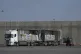 A worker unloads cargo from a truck carrying humanitarian aid for the Gaza Strip at the offload area of the Kerem Shalom border crossing between Israel and Gaza, May 22, 2025