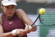 Emma Raducanu hits a backhand against Iga Swiatek during their second round match of the French Tennis Open, at the Roland-Garros stadium, in Paris, May 28, 2025