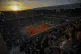 The sun sets during the second round match of the French Tennis Open between Denmark's Holger Rune and Emilio Nava of the United States at the Roland-Garros stadium in Paris, May 28, 2025