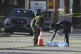 Investigators place a tarp over an item on a road near the site of an explosion in Palm Springs, Calif., May 17, 2025