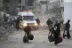 Palestinians evacuate after the Israeli army issued an evacuation warning for several schools and a hospital in Gaza City's Rimal neighbourhood, May 14, 2025