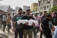 Saleh Zenati, carries the body of his infant nephew Khalid Zenati killed in an Israeli army airstrike, during his funeral in Khan Younis, Gaza Strip, May 18, 2025