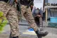 Indian soldiers patrol as a street vendor takes a nap after India and Pakistan reported no incidents of firing overnight, in Srinagar, Indian controlled Kashmir, May 12, 2025