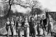 Members of the Women's Land Army (Land Girls) from various parts of the country, some with pitchforks over their shoulders. In the background is a shepherd's hut, used as a shelter during lambing