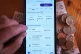 A person using a banking app on their phone in London, showing the amount of spending on bills, April 1, 2025