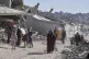 Displaced Palestinians fleeing Beit Lahia amid ongoing Israeli military operations in the Gaza Strip arrive in Jabalia, northern Gaza, May 16, 2025