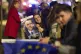 A supporter of presidential candidate Nicusor Dan smiles poses with an electoral poster after he won the second round of the country's presidential election redo in Bucharest, Romania, May 19, 2025