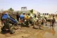 People fill water containers at a distribution point due to water outages in Khartoum, Sudan, May 25, 2025