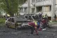 Municipal workers clean up around burnt cars in the residential area following Russia's drone attack in Kyiv, Ukraine, May 4, 2025