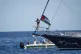 Climate activist Greta Thunberg stands near a Palestinian flag after boarding the Madleen boat and before setting sail for Gaza along with activists of the Freedom Flotilla Coalition, departing from the Sicilian port of Catania, Italy, June 1, 2025