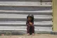 A Palestinian boy sits on the curb as he waits near a food distribution kitchen in Khan Younis, southern Gaza Strip, June 2, 2025