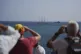 People take photos of vessels during the 