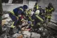 Emergency services personnel carry a body of a victim following a Russian rocket attack in Kharkiv, Ukraine, June 10, 2025