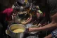 Palestinians receive donated food at a community kitchen in Gaza City, June 10, 2025