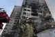 A firefighter calls out his colleagues at the scene of an explosion in a residence compound in northern Tehran, Iran, June 13, 2025