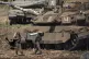 An Israeli soldier carries a shell next to a tank in northern Israel, September 27, 2024