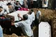 Relatives bury the coffins containing the remains of Rozar David Christian and his wife, Rachnaben Rozar Christian, both victims of the Air India plane crash, at a cemetery in Ahmedabad, India, June 15, 2025
