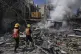 Palestinian firefighters work to extinguish a fire following an Israeli strike that destroyed a building in Deir al-Balah, central Gaza Strip, June 16, 2025