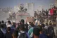 Palestinians ride on a truck loaded with food and humanitarian aid from the World Food Programme, after it arrived in the northern Gaza Strip en route to Gaza City, June 16, 2025