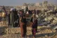 Palestinians carry sacks and boxes of food and humanitarian aid unloaded from a World Food Programme convoy that had been heading to Gaza City, in the northern Gaza Strip, June 16, 2025