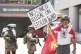 Jack Murillo, a Marine veteran, holds a sign in front of law enforcement guarding a federal building on Tuesday, June 17, 2025, in Los Angeles