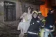 In this photo provided by the Ukrainian Emergency Service, firefighters evacuate a resident from a burning apartment building following Russia's massive air attack in Odesa, Ukraine, June 20, 2025