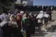 Palestinians line up to receive bags of flour distributed by the World Food Programme (WFP) in Gaza City, northern Gaza Strip, June 26, 2025