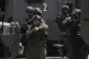 An Israeli soldier points his weapon during a military raid in the West Bank city of Nablus, June 10, 2025