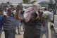 A Palestinian carries a bag containing food and humanitarian aid delivered by the Gaza Humanitarian Foundation, a U.S.-backed organisation, in Rafah, southern Gaza Strip, June 11, 2025