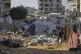 Palestinians inspect damaged tents after an Israeli strike hit a displacement camp in Gaza City, June 28, 2025
