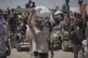 Palestinians carry food and humanitarian aid packages delivered by the Gaza Humanitarian Foundation, a U.S.-backed organization, in Rafah, southern Gaza Strip, June 26, 2025
