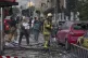 Firefighters and people clean up the scene of an explosion at a residence compound after Israeli attacks in Tehran, June 13, 2025